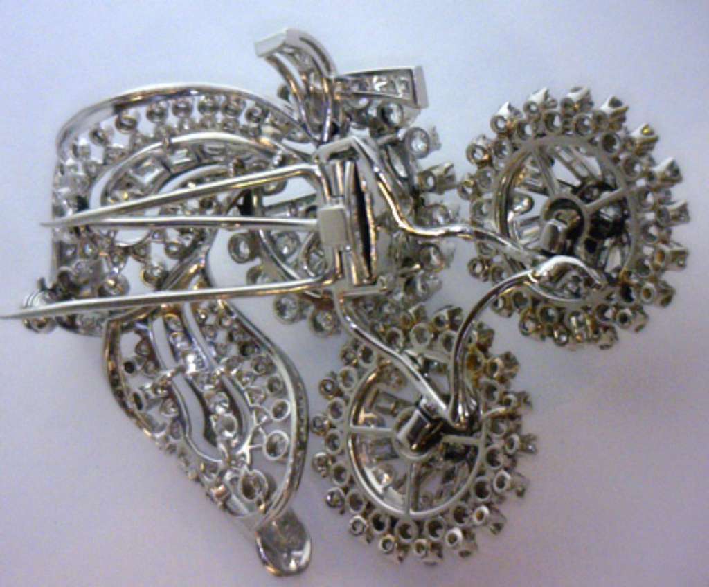 Profile view of platinum brooch showcasing intricate craftsmanship and multiple diamond cuts