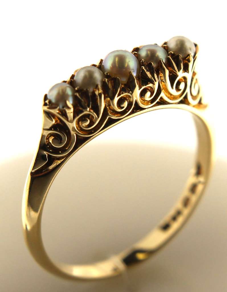 Close-up of 14kt yellow gold ring featuring five white seed pearls with a polished finish, weight of 3.12 grams, ring size 6.5