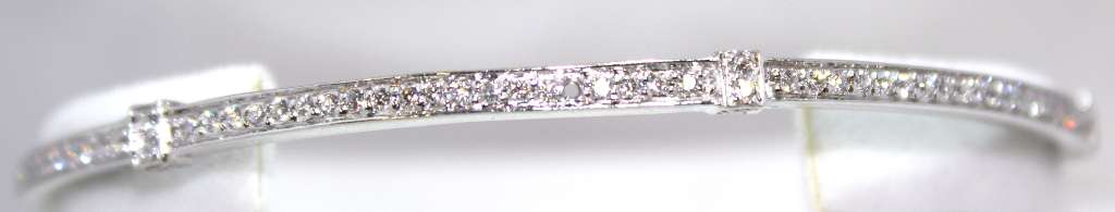 Close-up of 18kt white gold bangle featuring 144 round brilliant cut diamonds with VS-SI1 clarity and G-H color