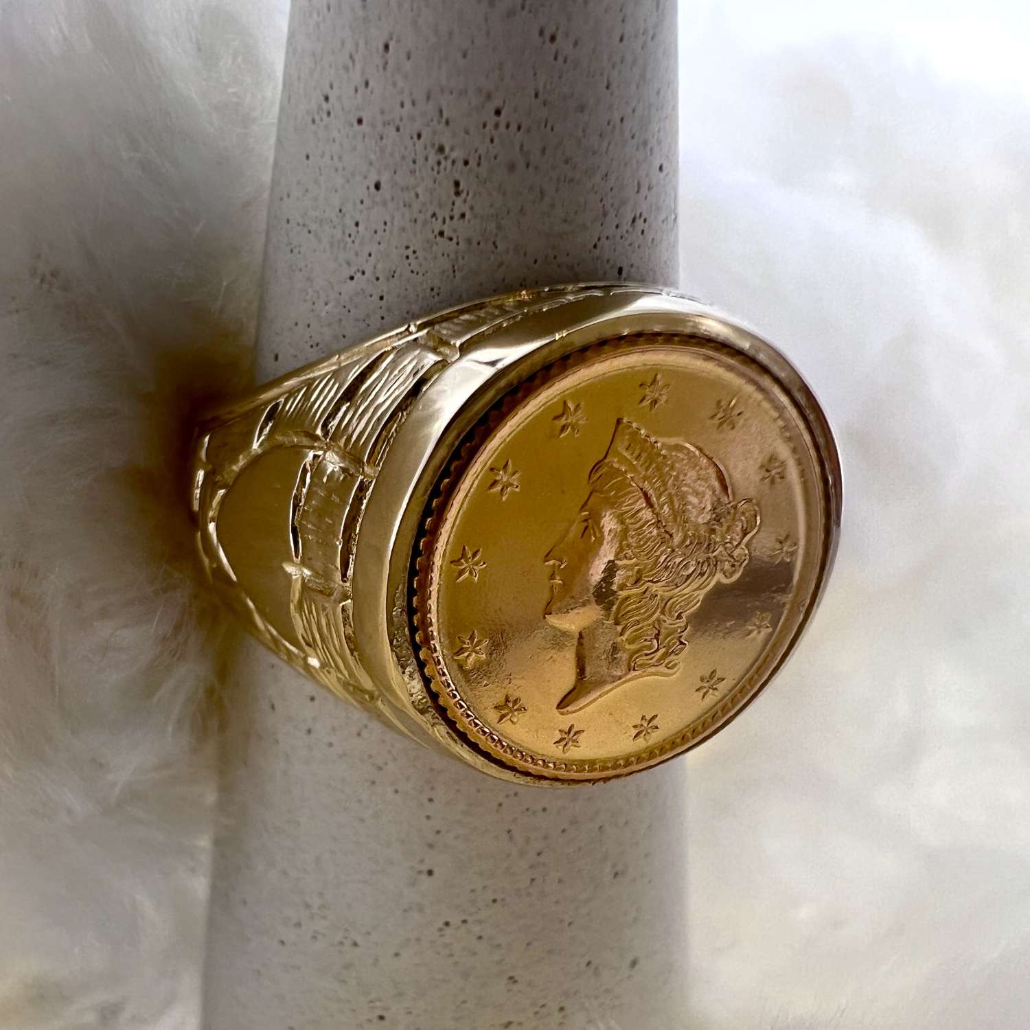 Close-up of 14kt yellow gold coin ring with bezel set American $1 gold coin, ring size 7.5