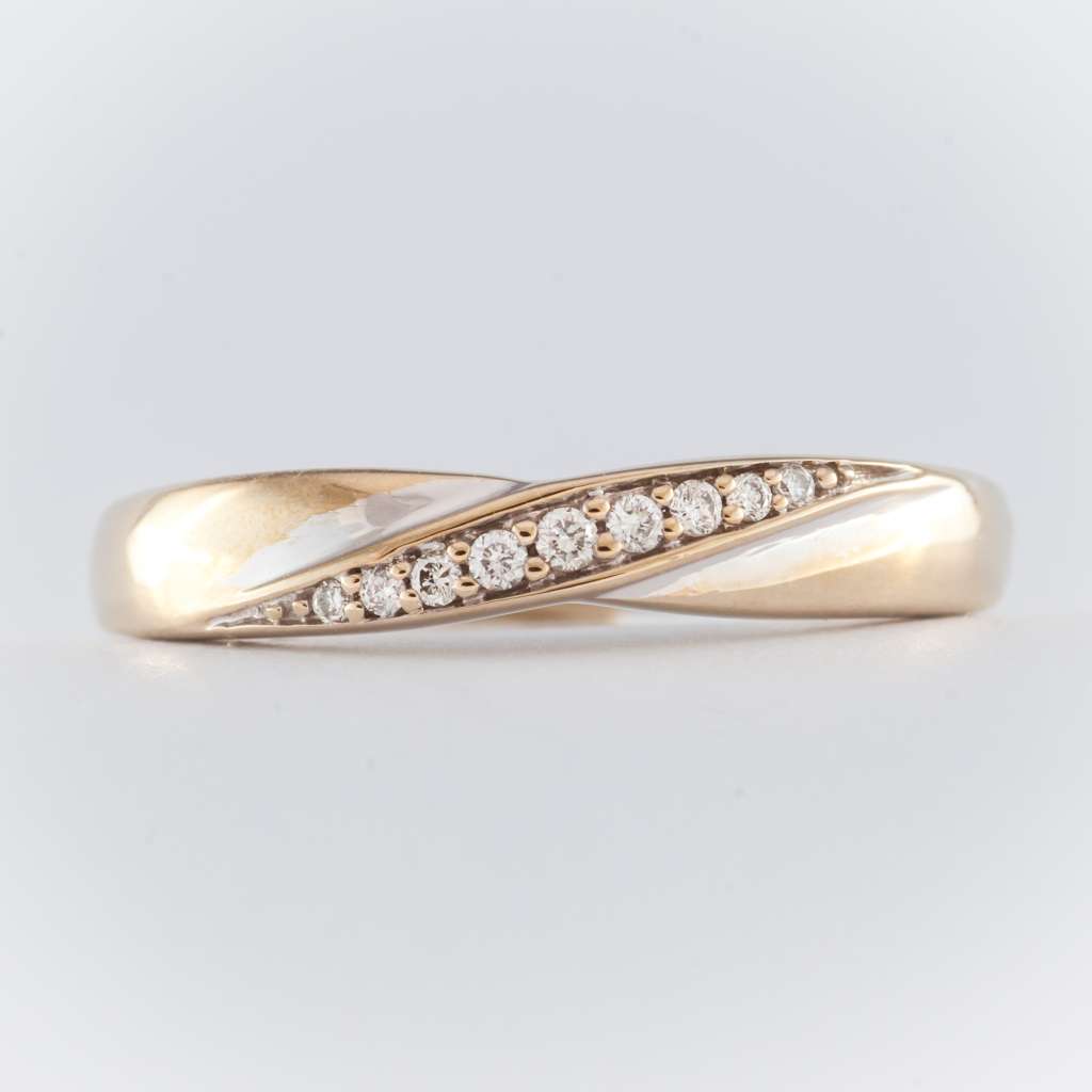 Top view of 14kt white gold ring with nine small round diamonds set evenly around the band