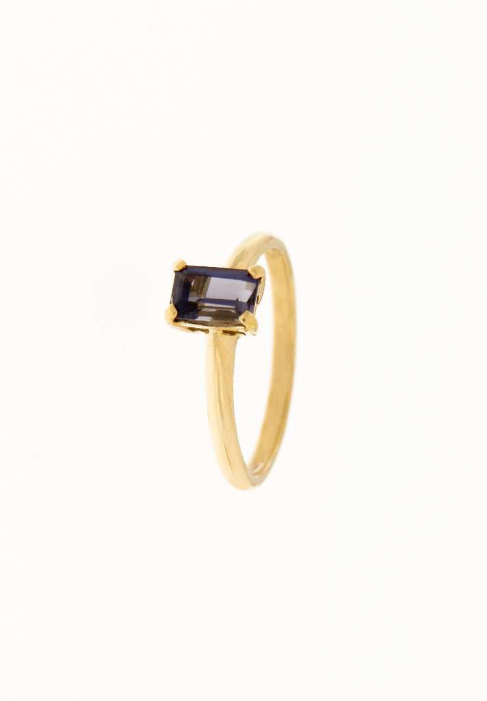 Angled view of vintage 18K yellow gold ring highlighting emerald-cut Iolite and delicate band design