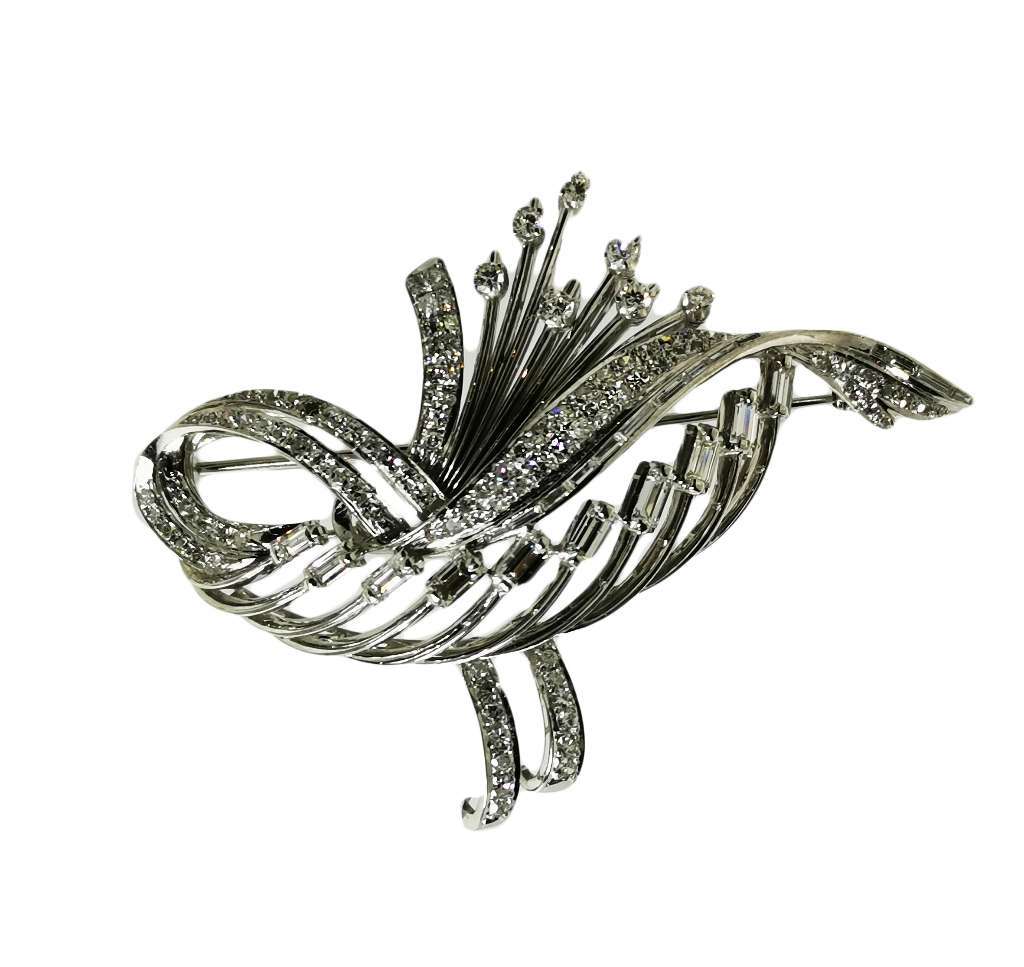 Close-up view of antique silver and white gold diamond brooch featuring 24 baguette cut diamonds and intricate filigree detailing, weighing 17.37 grams