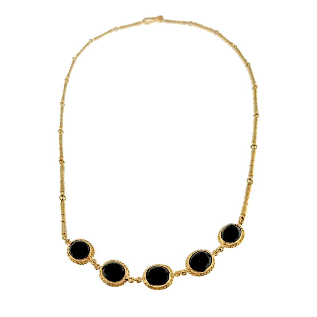 Close-up of 9kt yellow gold necklace with five oval black onyx cabochon stones set in full bezel, view of pendant details