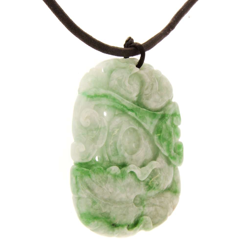 Close-up of Burmese jadeite pendant highlighting detailed carving of birds and Ruyi symbol in medium green jade