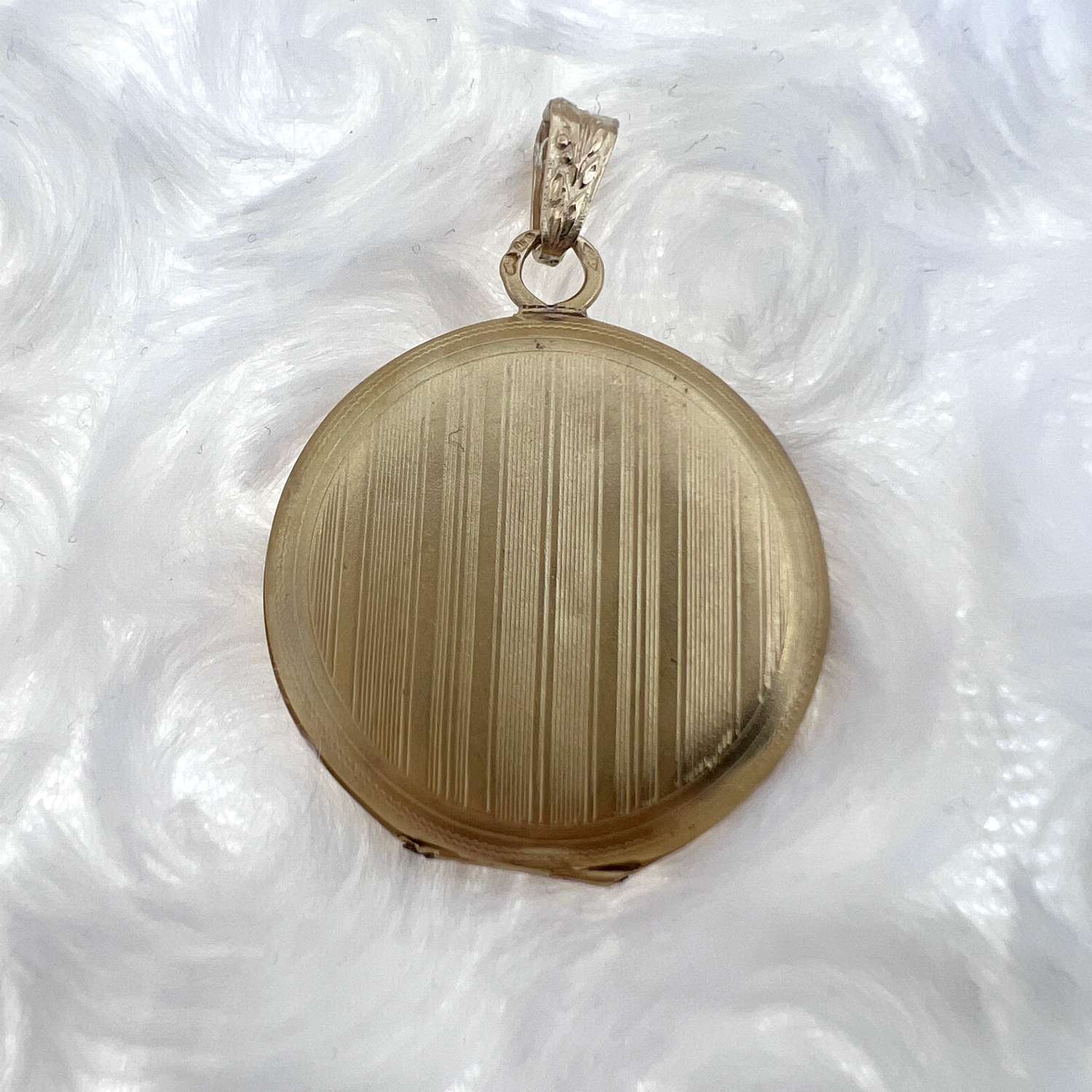 Open view of 18kt yellow gold round locket pendant, interior compartment visible