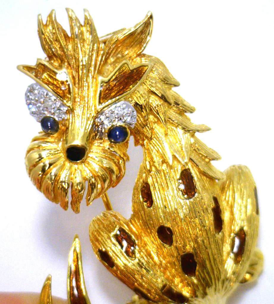 Back side of 18kt yellow gold dog brooch highlighting the clasp mechanism and gold purity stamp