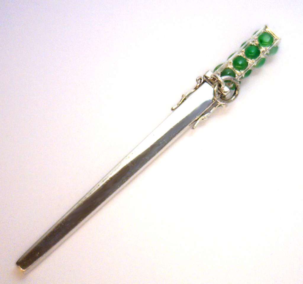 Detailed side angle of collectible 14kt white gold jade pendant highlighting thickness, craftsmanship, and brilliant jade stones