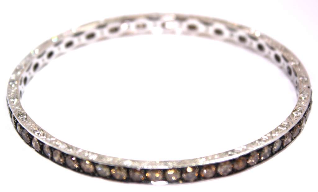 Detailed side view of 18kt white gold diamond bangle highlighting the flawless setting of 114 round brilliant cut diamonds