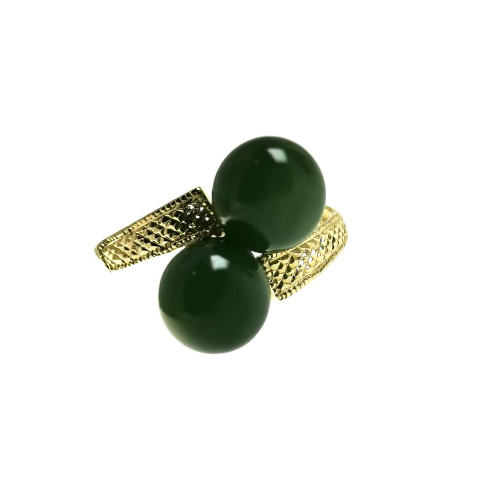 Close-up of 10kt yellow gold ring featuring two round green BC jade beads approximately 7.5mm each, showcasing the polished band and jade's natural luster