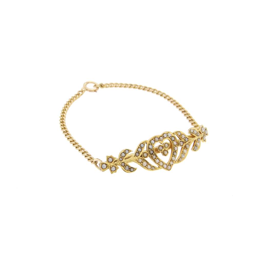 Detailed image of heart motif with clusters of white seed pearls on 14kt yellow gold bracelet