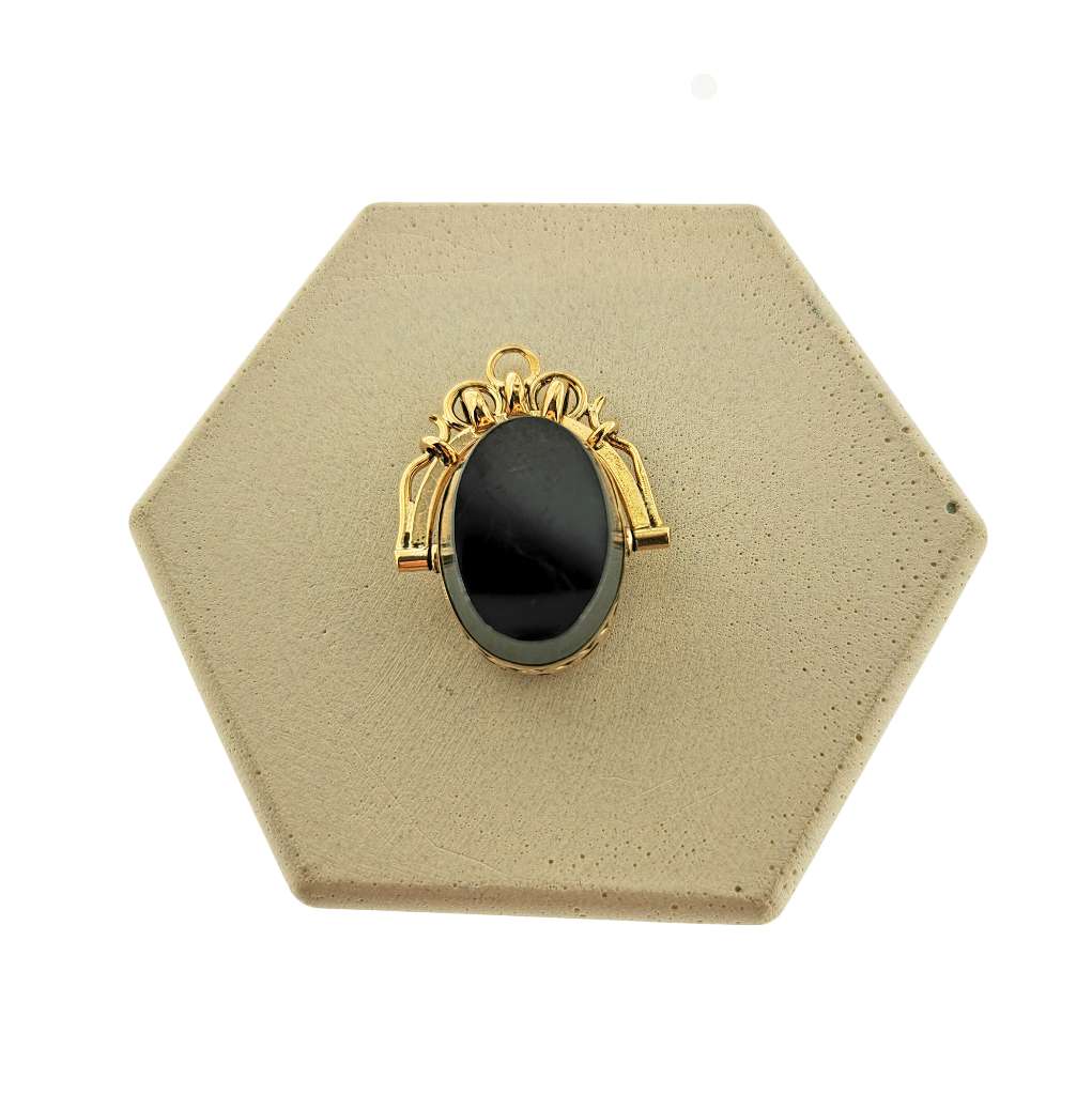 Reverse side of 14kt yellow gold fob set with polished hematite stone, close-up angle