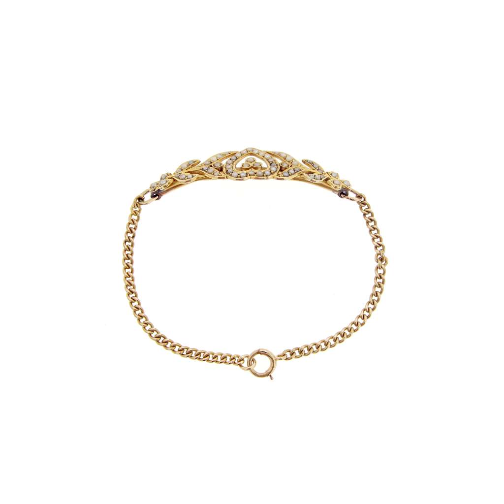 Side view of fine 14kt yellow gold bracelet showcasing the seed pearls and curb link craftsmanship