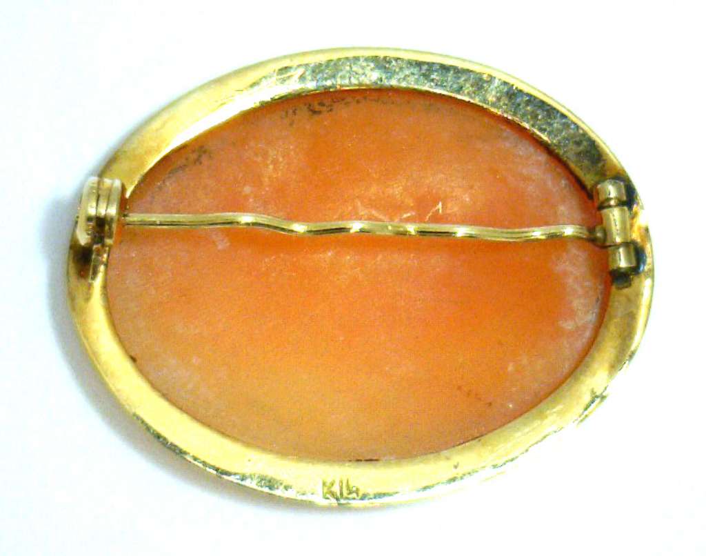Top view of vintage 14kt yellow gold cameo brooch showcasing detailed shell cameo with polished gold frame, highlighting 2.74 gram weight elegance