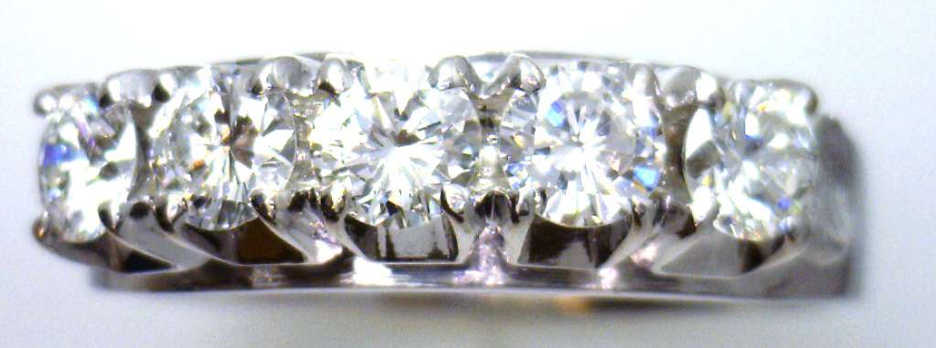 Close-up side angle of ladies' white gold diamond ring highlighting the diamond settings and polished band