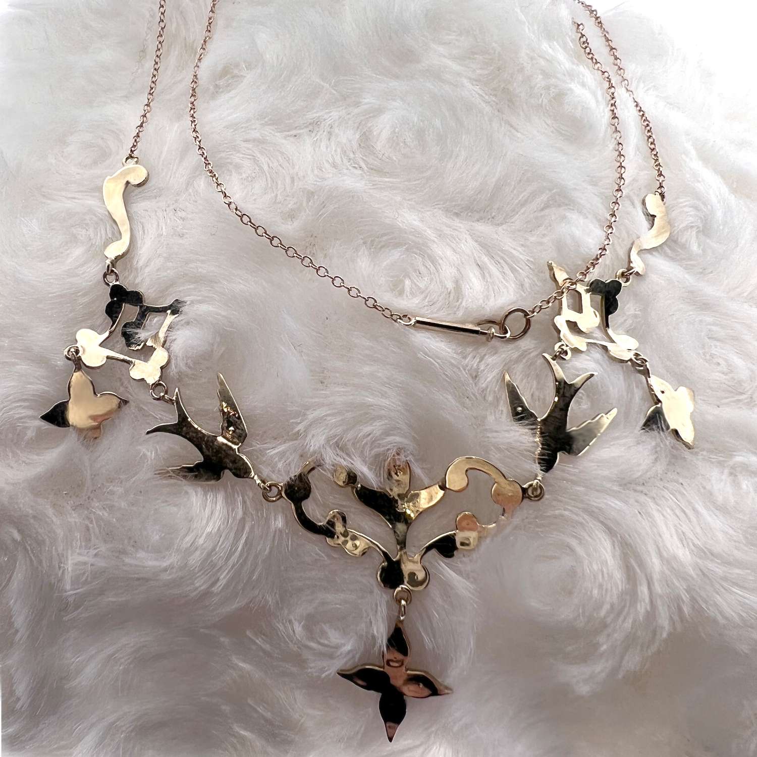 Side angle of 14kt yellow gold seed pearl necklace showcasing delicate pearl settings and cable link chain