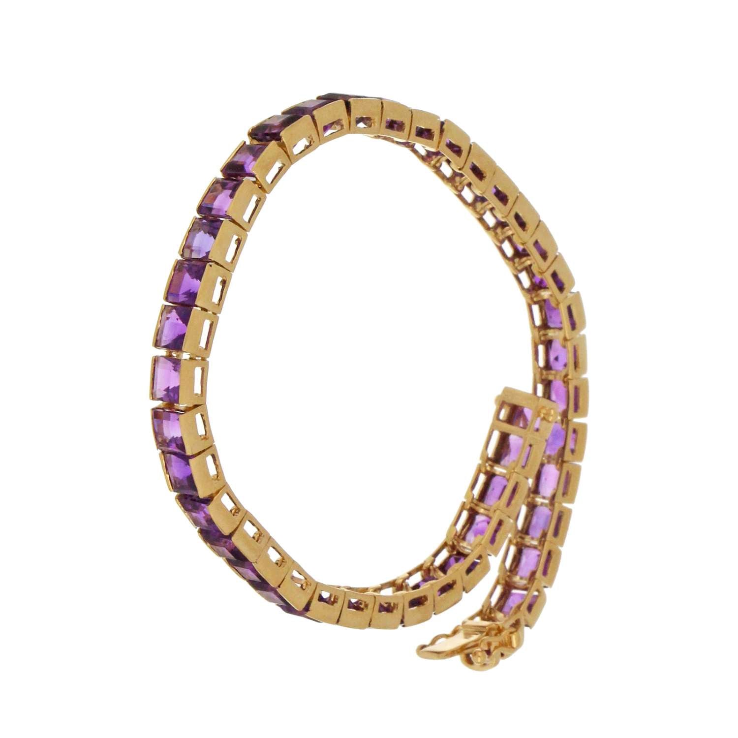 Side angle showing 14kt yellow gold band with 44 square amethyst gemstones in channel setting