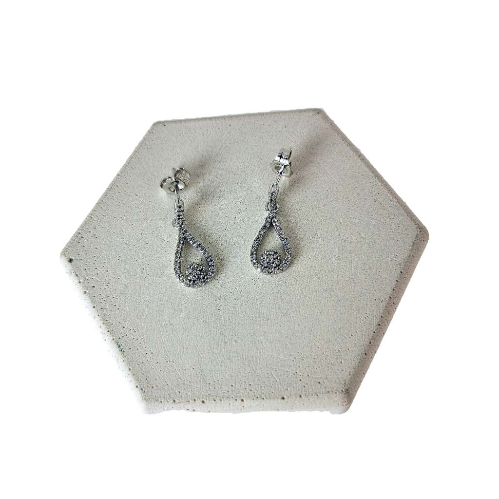 Side angle of 10kt white gold dangling earring highlighting intricate diamond setting and elegant design