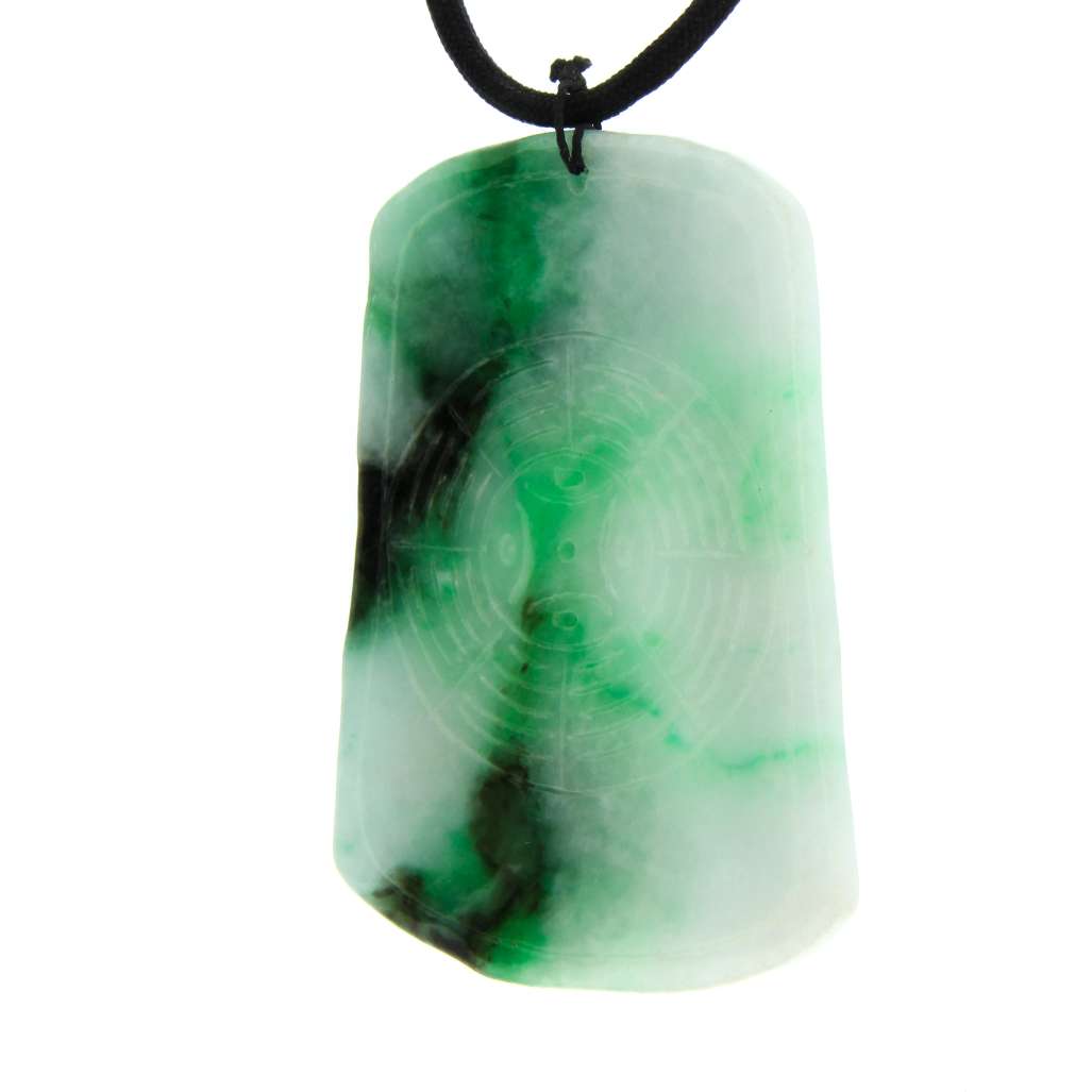 Detailed view of the jadeite jade pendant’s finely carved Chinese brush pen symbols in varying green shades