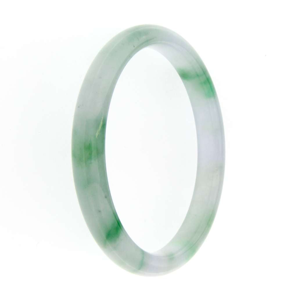 Side angle of Burmese natural jadeite jade bangle showing translucent light green color and smooth domed surface