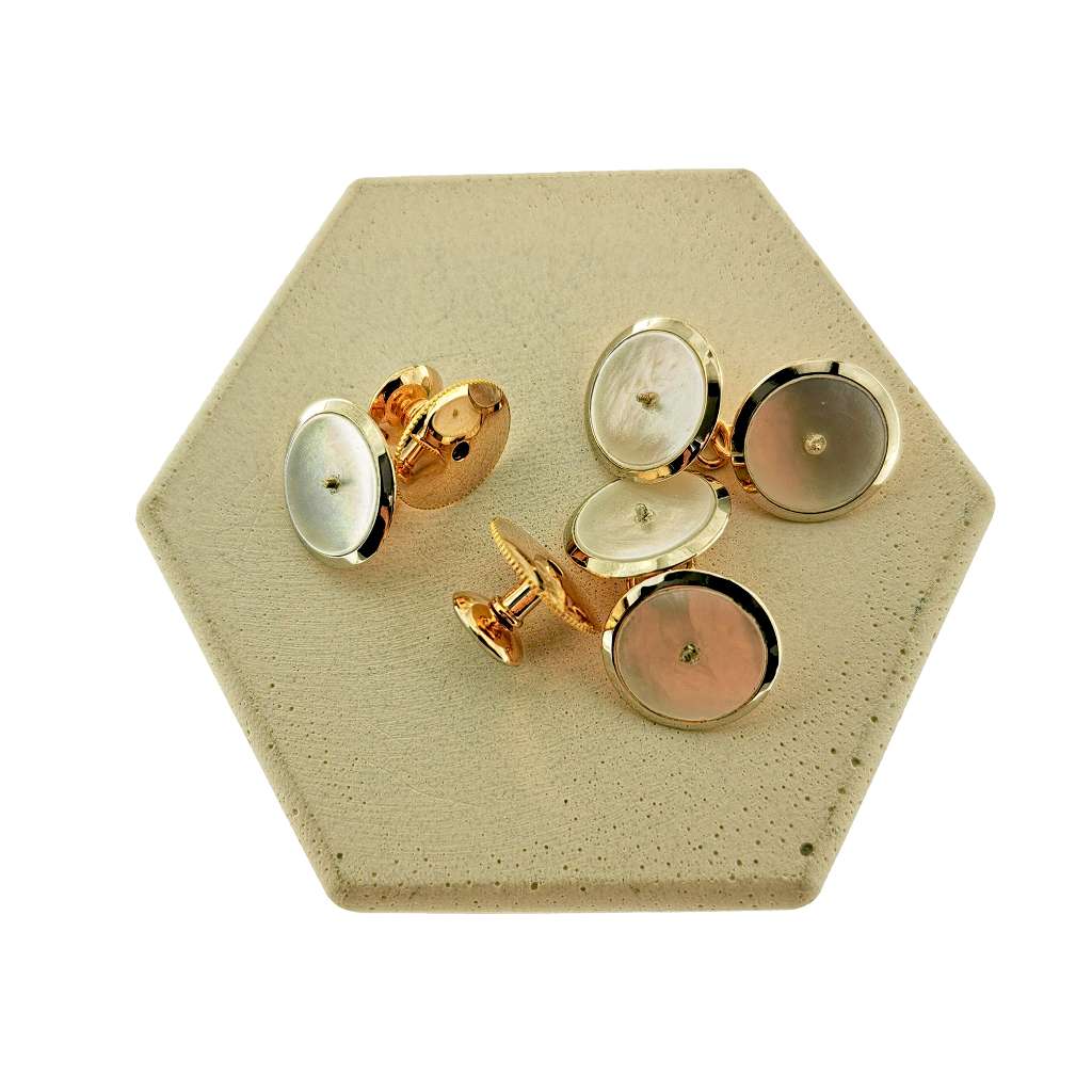 Gold cufflink and button stud set shown from angled view