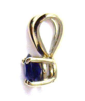 Side view of 14kt white gold pendant showcasing the setting of the round blue sapphire stone and the fine craftsmanship